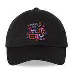 A black cap that reads "Turns Out I'm Pretty Gay" and has little star illustrations around it. From Pretty Gay.