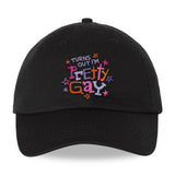A black cap that reads "Turns Out I'm Pretty Gay" and has little star illustrations around it. From Pretty Gay.
