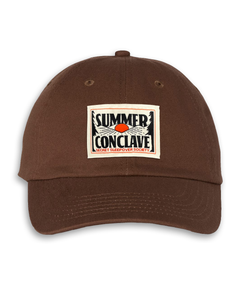 Brown hat with heat pressed woven label that says "Summer Conclave" and a sunrise that looks like an eye.