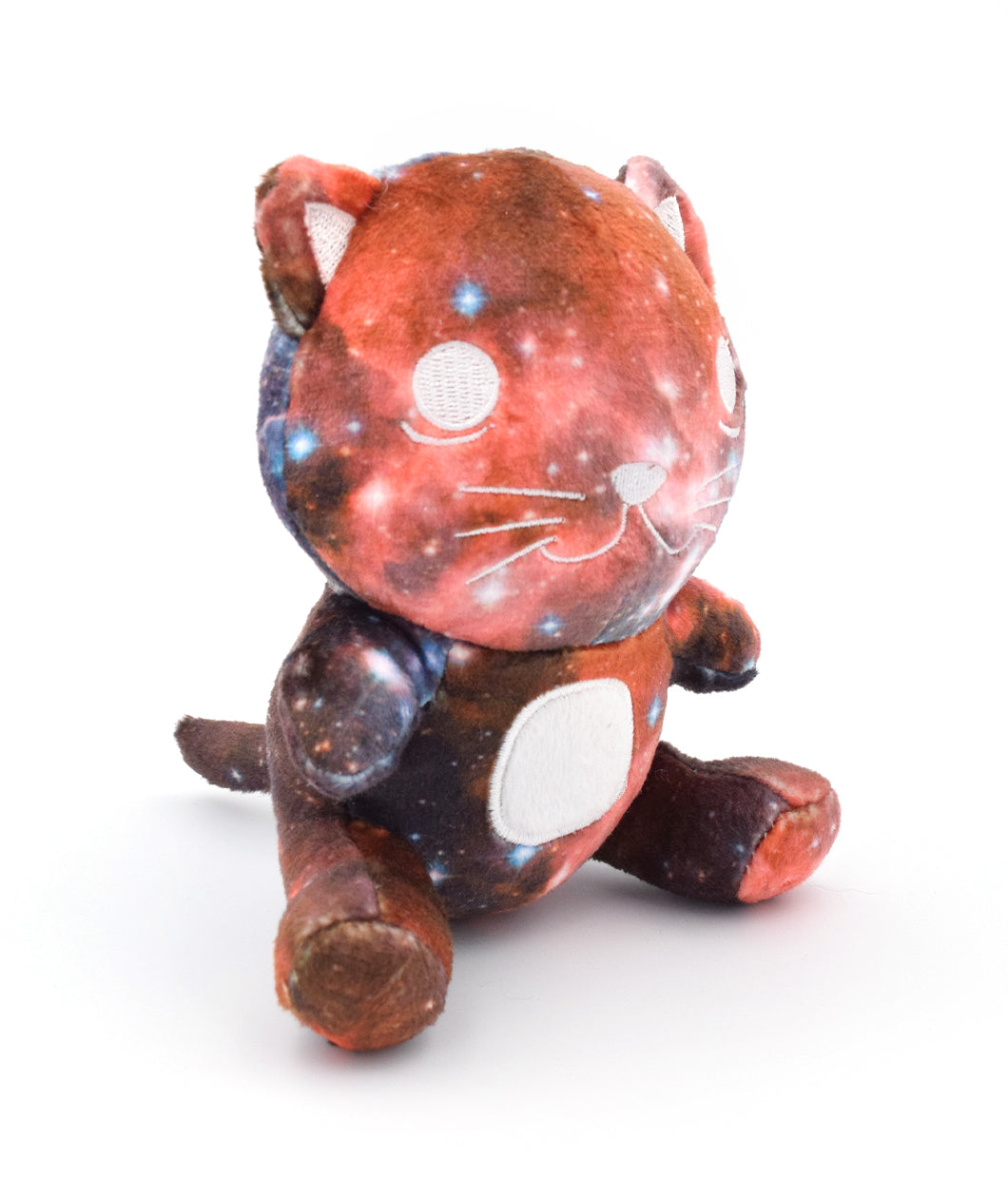 The living galactic Schrodinger's Cat that has galaxy plush fabric and a white embroidered face that is smiling because it is alive. 5.5" tall in sitting position.