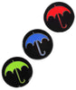 Three circular black pins each with an umbrella on them in a different color: red, blue and bright green. From Bill Wurtz.