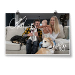 A signed photo of a couple, their baby, and their 3 dogs sitting on a couch - by Charles Trippy