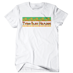 A white t-shirt with a colorful rectangle of pattern across the front. Dissecting the pattern is "Three Black Halflings" written in colorful letters.  
