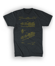 The front of a gray short-sleeved t-shirt featuring a blueprint of a funicular in yellow - by 99% Invisible