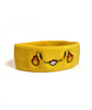 A yellow sweatband with a smiling face that has a fireball on the side of each eye - by Brian David Gilbert 