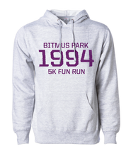 Heather white hoodie with large red 1994 in the front center and "Bitmus Park 5K Fun Run" sandwiched around it in smaller font. The hoodie has a front pocket on the bottom. By Brian David Gilbert 