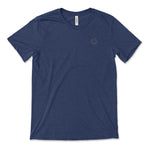 A dark blue t-shirt with a small, subtle beaker logo from CGP Grey in the top left area of the shirt. 
