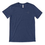 A dark blue t-shirt with a small, subtle beaker logo from CGP Grey in the top left area of the shirt. 
