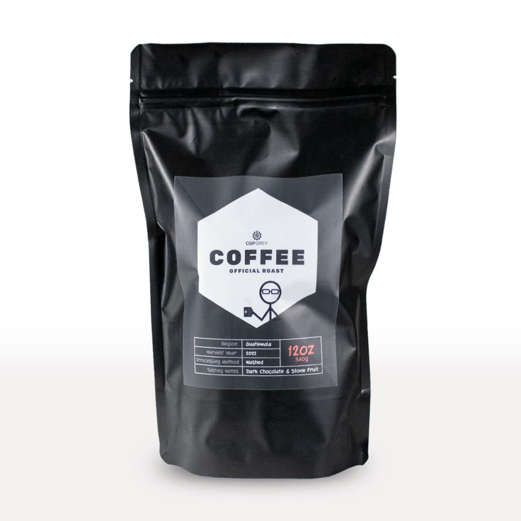 A black bag of coffee with a label on the front with a white hexagon with the words "CGP Grey; COFFEE; Official Roast" and a stick figure with glasses holding a mug. 