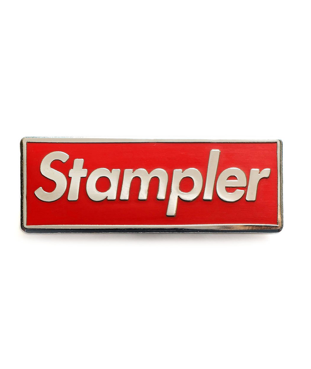 Silver plated rectangular enamel pin with red enamel and the word Stampler in silver in the center.