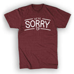 A red t-shirt the the words "We're" above the larger word "Sorry". A small Drawfee logo mug is below the word "Sorry". 