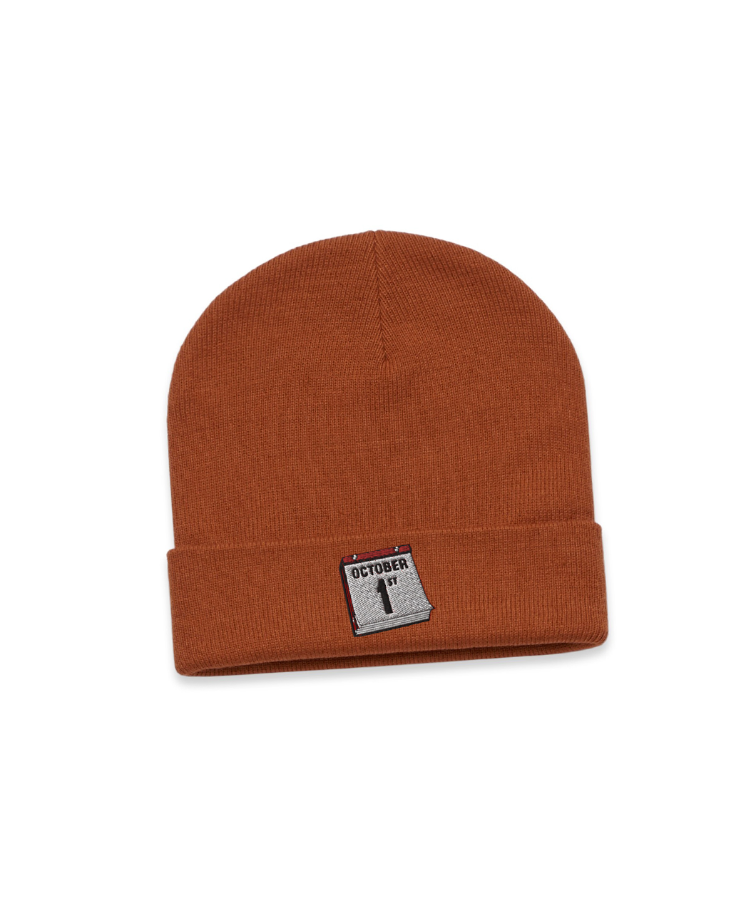 An orange beanie with a small calendar page turned to October 1st embroidered on the front.