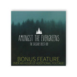 A square image of an out of focus silhouette of a forest. “Amongst the Evergreens The Cascade Crest 100” is written in tall white sans serif font in the center below a silhouette vector image of three white trees. “Bonus Feature Over an hour of additional footage” is on the bottom in dark yellow sans serif font - from The Ginger Runner