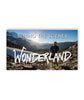 A rectangular image of a mountainous landscape with two people hiking on a trail with the sun rising behind. “Behind the scenes” is in white sans serif font at the top. “Wonderland Gary Robbins Run Around Rainier” is at the bottom in white sans serif font - from the Ginger Runner