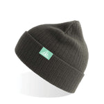 A gray beanie with a teal tab on the cuff. On the tab is a white outlined triangle surrounding a silhouette of a tree. On the left side of tree is “G” and on the right is “R” in white font. Both are conformed to the angle of the triangle - from the Ginger Runner