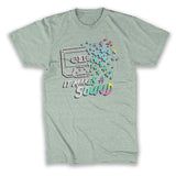 A mint t-shirt  with a cassette tape dissolving into colorful stars. The words "It Makes a Sound" are written below.