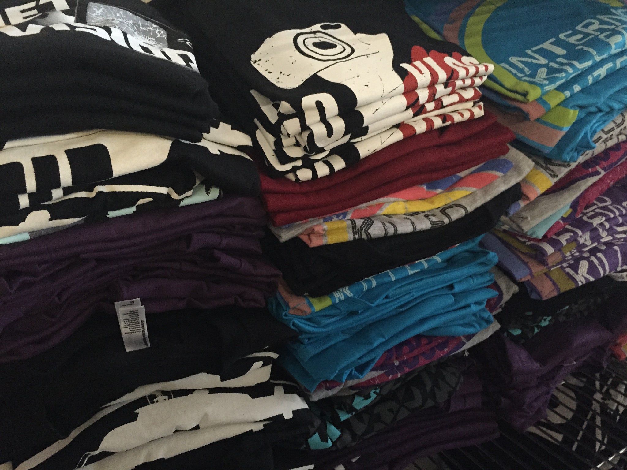 3 stacks of t-shirts - by Charles Trippy
