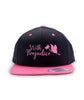 Black hat with a pink brim. “With Prejudice” is in cursive pink font on the front with a pink butterfly holding a pink gavel to the right of the text - from Lindsay Ellis