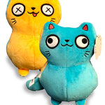 One side of cat plushie is blue with two legs at the bottom and a tail. Two white eyes with black outline with pupils looking in opposite direction. Face has mouth, nose, and whiskers. Two ears are at top with pink triangles. Other side is yellow with same details, but eyes have X’s in them and tongue is hanging out of mouth - from Physics Girl