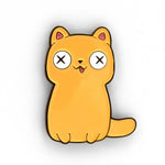 Yellow cat pin with a thin black outline. Two small paws at the bottom with a tail coming out at the bottom right. Tongue is hanging out and eyes are white with two black X’s in its eyes - from Physics Girl