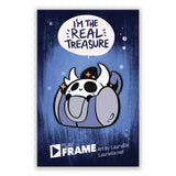 A blue pin backing that has a text bubble that says "I'm the real treasure" above a blue, black and white pin with the text PlayFrame. 