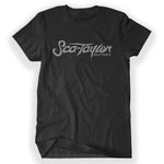 Black shirt with “Sca-Taylor” in gray organic cursive font. Below on the bottom right, “Guitars” is in gray organic font - from Rob Scallon