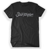 Black shirt with “Sca-Taylor” in gray organic cursive font. Below on the bottom right, “Guitars” is in gray organic font - from Rob Scallon