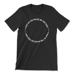 A black t-shirt that has text in a circle that reads "Put in the miles so you can " repeating twice with an arrow in between. From Semi Rad. 