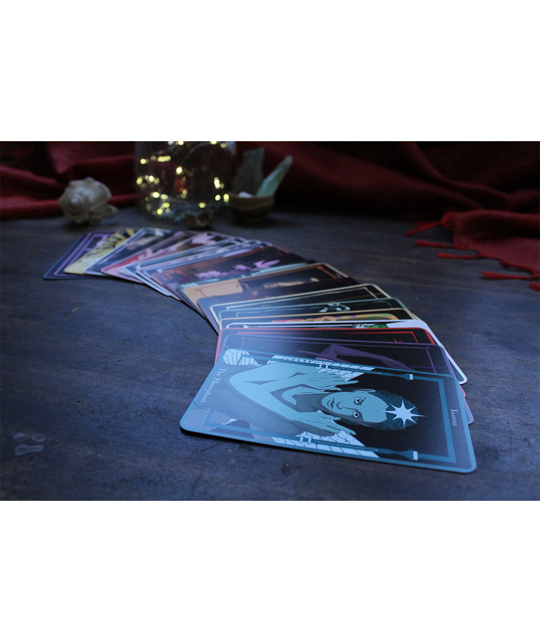 A set up tarot cards fanned out in a semi circle on a dark table. From Spirits. 