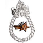 A sterling silver chain bracelet circling around an orange star with three orange lines trailing behind it on a silver backing - from This Star Won’t Go Out.