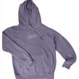 A purple hoodie with the embroidered words "I'm thinking about books." across the chest and a small book on the right cuff in light blue.