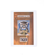 A white greeting card with a photo on the front of an orange monochrome image of a person. “Confidence in your Tiger” is in black sans serif font split on top and bottom of an image of a cartoon cat - from The Art Assignment