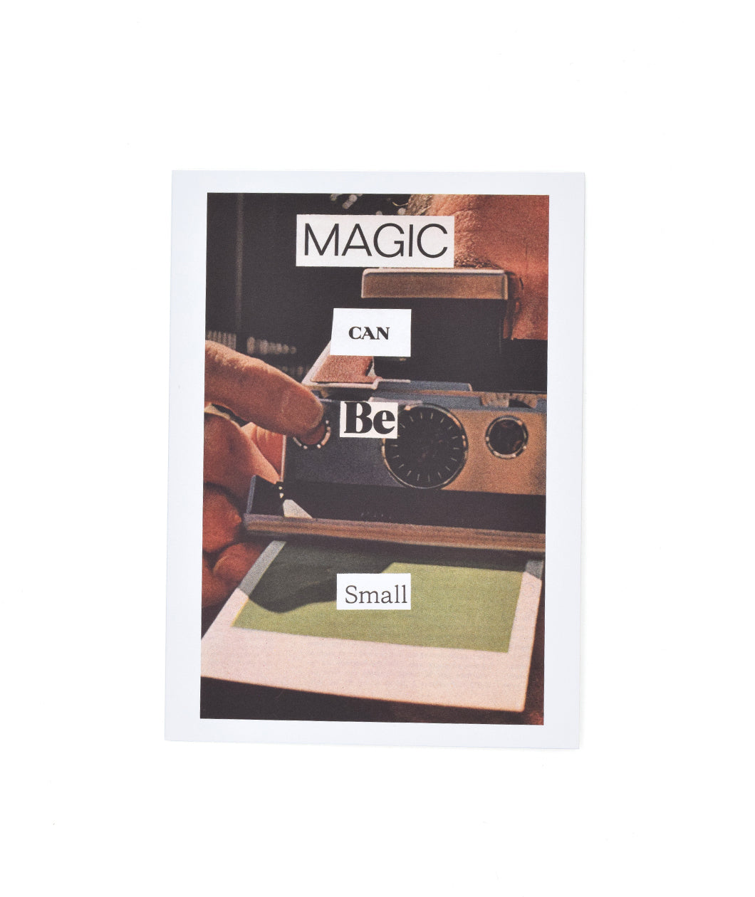 A white greeting card with an image of a person taking a photo on a Polaroid camera. “Magic can be small” is in black font in varying text, each word spaced over the entire card - from the Art Assignment