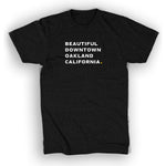 Black unisex t-shirt with white words "Beautiful Downtown Oakland California" on the center chest - by 99% Invisible