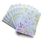 Yellow bird footprints and red sprinkle of seeds. Multple greeting cards are fanned out from behind. “Bird Hop” is written in top left of image in black sans serif font indicating which greeting card is being shown - from Animal Wonders