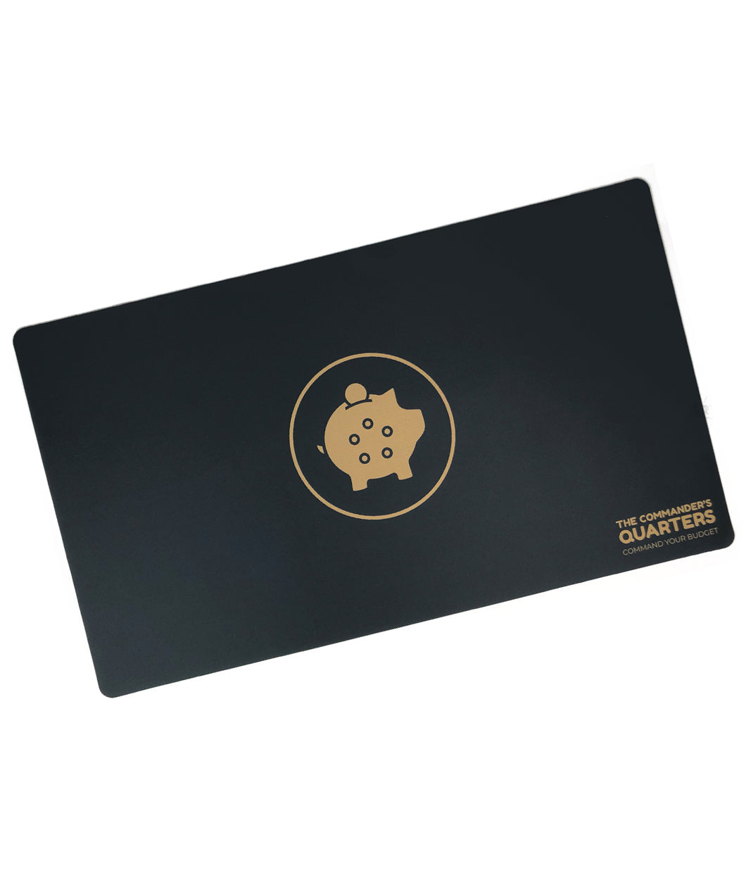 A black rectangular playmat with curved corners. In the center is a gold outlined circle. A gold piggy bank is in the center with a coin being inserted. On the pig are five black outlined circles. “The Commander’s Quarters” is in the bottom right in gold sans serif font - from The Commaner’s Quarters