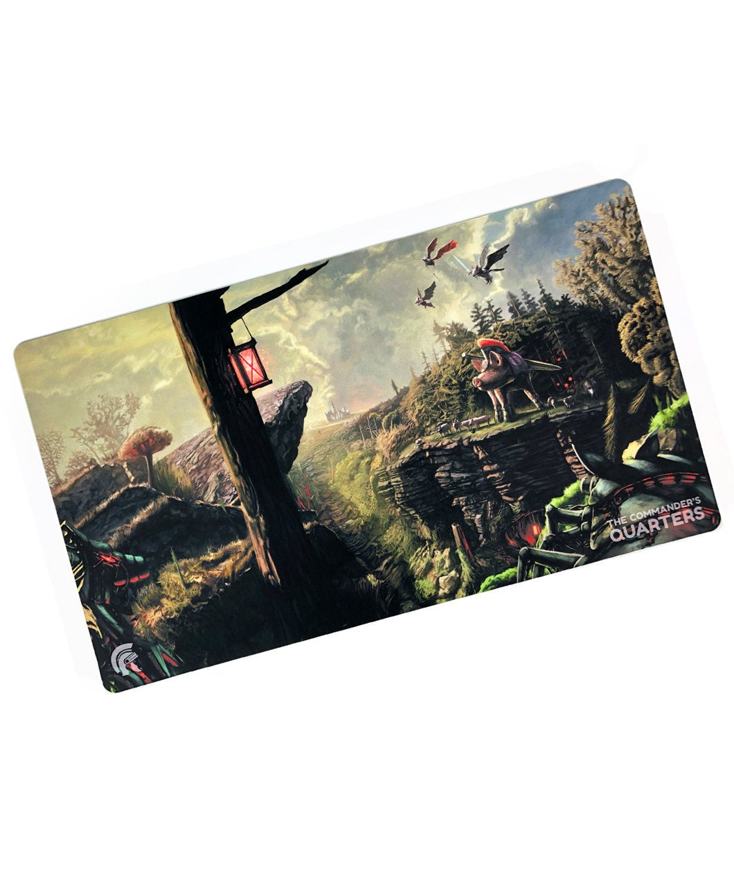 A rectangular playmat with curved edges. The playmat shows a an image of varying creatures standing on the edge of a ravine in front of a forest. A tree with a red lantern is in the foreground with a castle in the background. Three winged creatures fly above - from the Commander’s Quarters