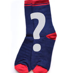 A pair of dark blue crew socks with a red toe, heel and band at the top. There is a grey question mark overplayed on top of them. 