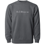 Gray crewneck sweatshirt with “don’t blame me” across chest in white cursive font - from Don’t Blame Me