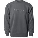 Gray crewneck sweatshirt with “don’t blame me” across chest in white cursive font - from Don’t Blame Me