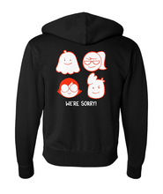 The back view of a black zip-up hoodie with four different Drawfee icons with the text "we're sorry!". 
