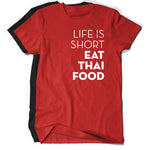 A bright red t-shirt with the words "Life Is Short Eat Thai Food" written down the right side. There is a black t-shirt behind. From Hot Thai Kitchen. 