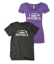 Black shirt and purple curved cut shirt both with “I” in white sans serif font followed by a vector drawing of Newtons cradle. A heart takes the place of one of the balls. Below, “Physics” is in white sans serif font - from Physics Girl