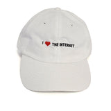 A white baseball cap with the phrase "I <3 The Internet" on the front in black and red - by Charles Trippy