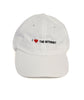 A white baseball cap with the phrase "I <3 The Internet" on the front in black and red - by Charles Trippy
