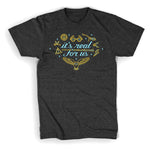 Grey shirt with “It’s real for us” in light blue cursive font surrounded by line drawings of various Harry Potter objects in gold with light blue highlights. Light blue stars in various sizes also surround text - from Lauren Fairweather