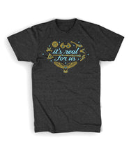 Grey shirt with “It’s real for us” in light blue cursive font surrounded by line drawings of various Harry Potter objects in gold with light blue highlights. Light blue stars in various sizes also surround text - from Lauren Fairweather