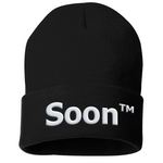 A black beanie with “Soon” in white sans serif font across the front. Following the word is “TM” at the top right of the word in white sans serif font - from JoCo Cruise