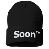A black beanie with “Soon” in white sans serif font across the front. Following the word is “TM” at the top right of the word in white sans serif font - from JoCo Cruise