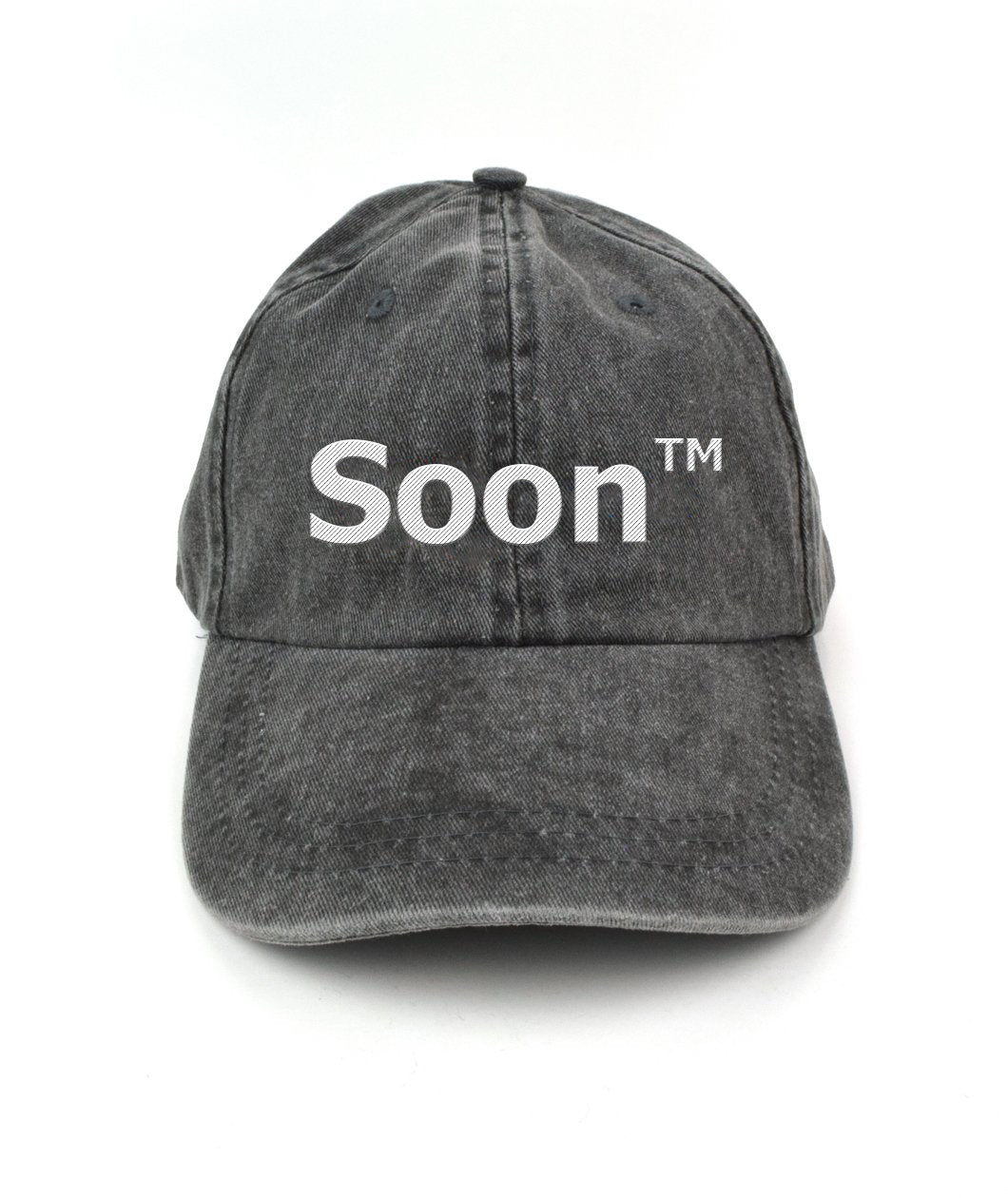 A gray hat with “Soon” in white sans serif font across the front. Following the word is “TM” at the top right of the word in white sans serif font - from JoCo Cruise